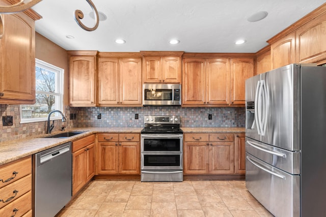 kitchen featuring decorative backsplash, recessed lighting, stainless steel appliances, and a sink