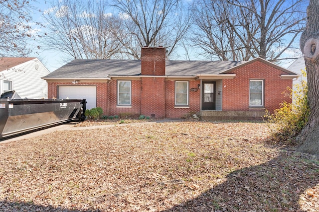 back of house featuring a garage, brick siding, and a chimney