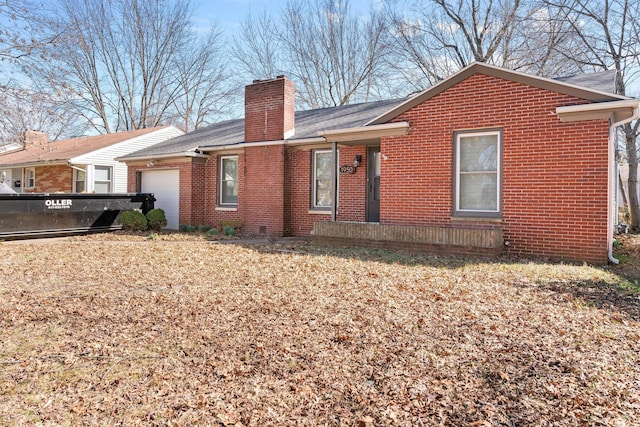 back of property featuring brick siding, a chimney, and an attached garage