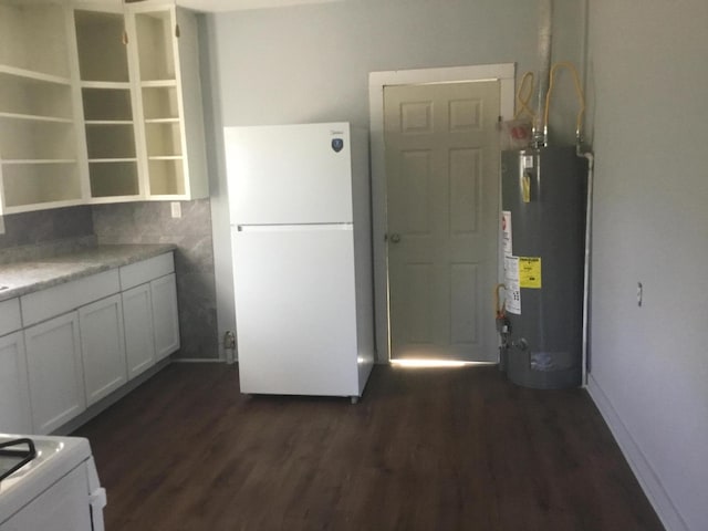 kitchen with open shelves, dark wood-style floors, water heater, freestanding refrigerator, and light countertops