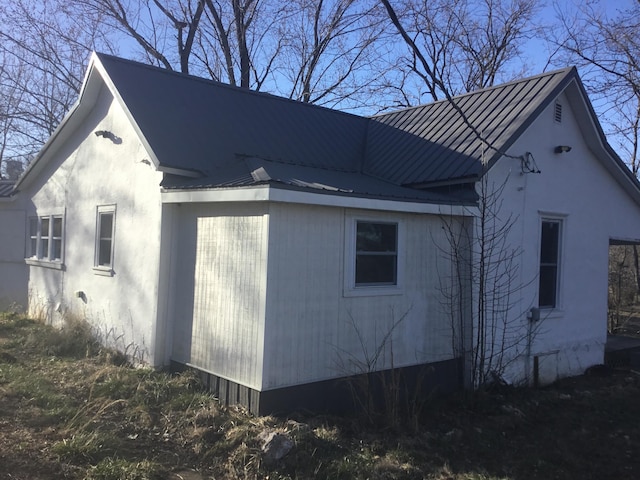 view of property exterior featuring metal roof