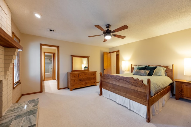 bedroom featuring a ceiling fan, baseboards, visible vents, a textured ceiling, and light carpet