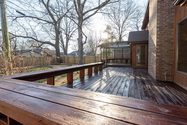 wooden deck with fence and a sunroom