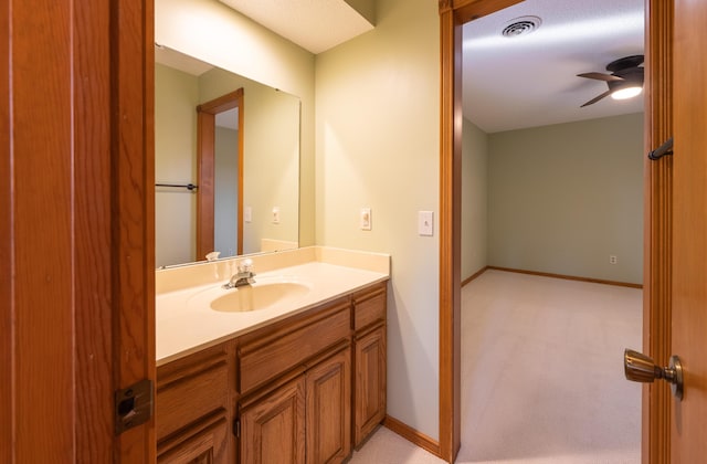 bathroom with visible vents, baseboards, vanity, and a ceiling fan