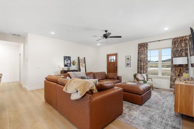 living room featuring recessed lighting, baseboards, visible vents, and light wood-type flooring