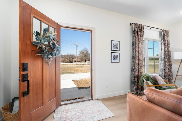 entrance foyer with light wood-type flooring and baseboards