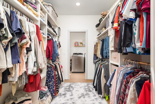 walk in closet featuring washer / clothes dryer and wood finished floors