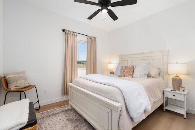 bedroom featuring wood finished floors, baseboards, and ceiling fan