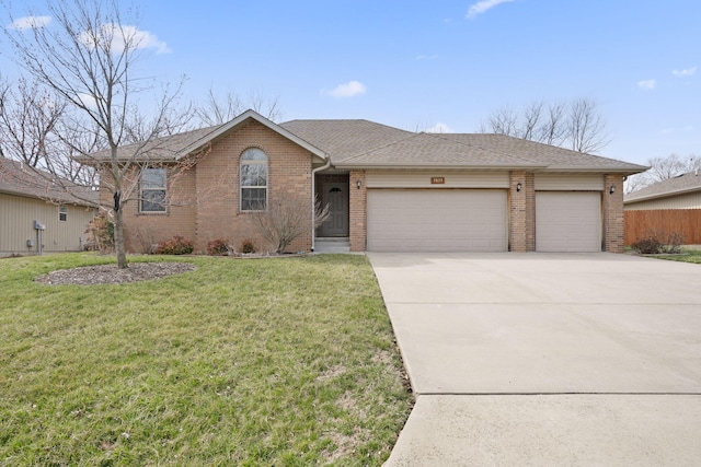 ranch-style house with brick siding, a shingled roof, a front lawn, a garage, and driveway