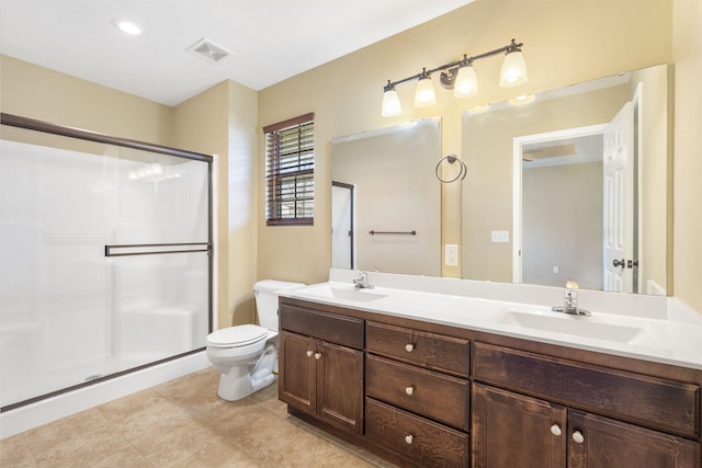 bathroom featuring a shower stall, toilet, visible vents, and a sink