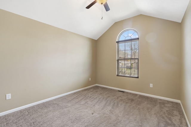 empty room with visible vents, baseboards, carpet, lofted ceiling, and a ceiling fan