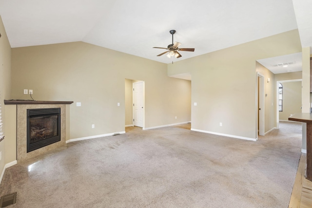 unfurnished living room featuring visible vents, lofted ceiling, a ceiling fan, and a high end fireplace