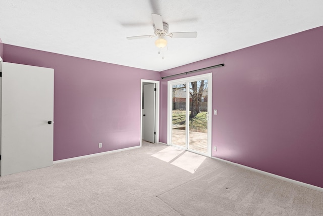 carpeted spare room with baseboards and ceiling fan