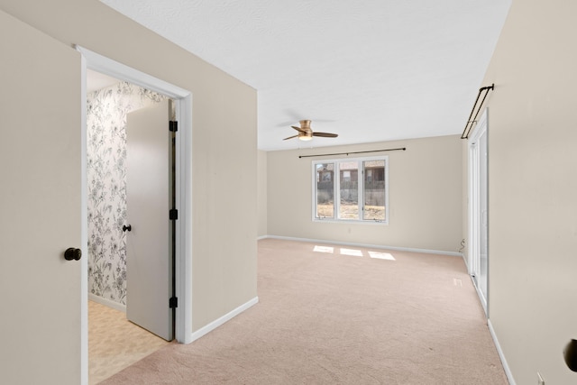 corridor with light colored carpet and baseboards