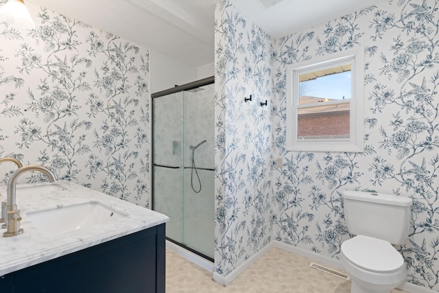 full bath featuring visible vents, wallpapered walls, a sink, a shower stall, and toilet