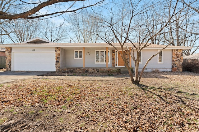 ranch-style house with stone siding, concrete driveway, and a garage