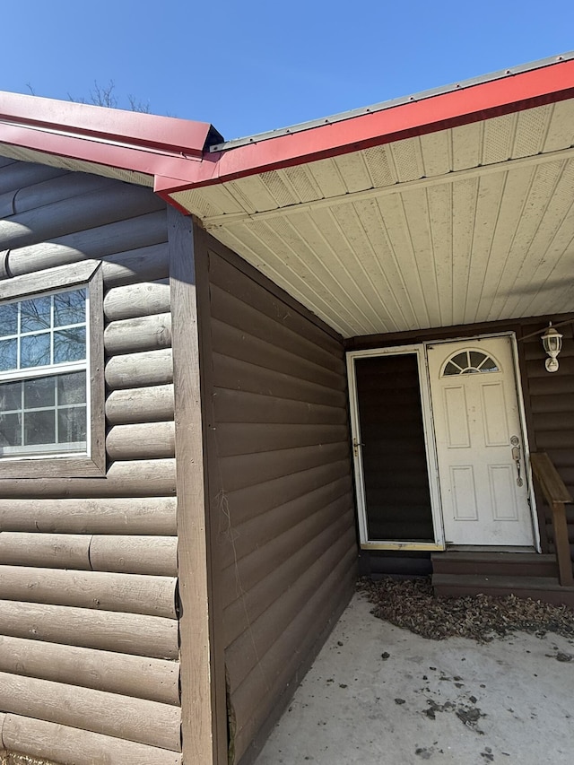 entrance to property with faux log siding