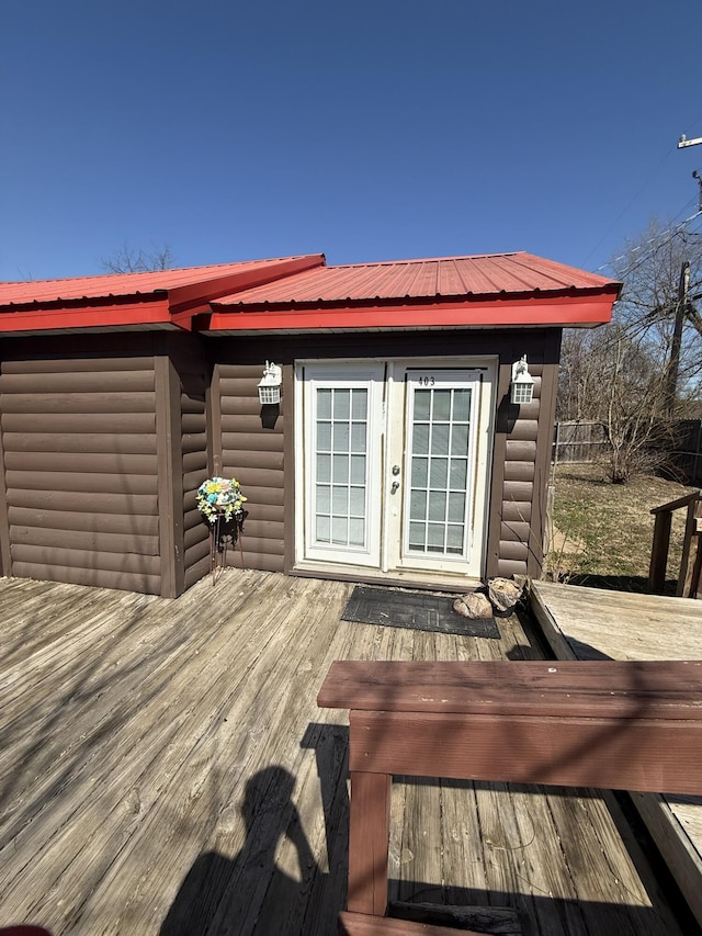 wooden terrace with an outbuilding and fence