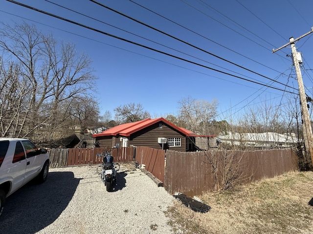 view of property exterior featuring fence private yard