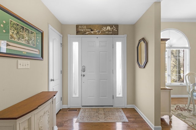 entryway with baseboards and wood finished floors