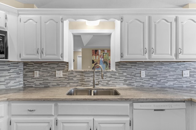 kitchen with dishwasher, white cabinetry, and a sink