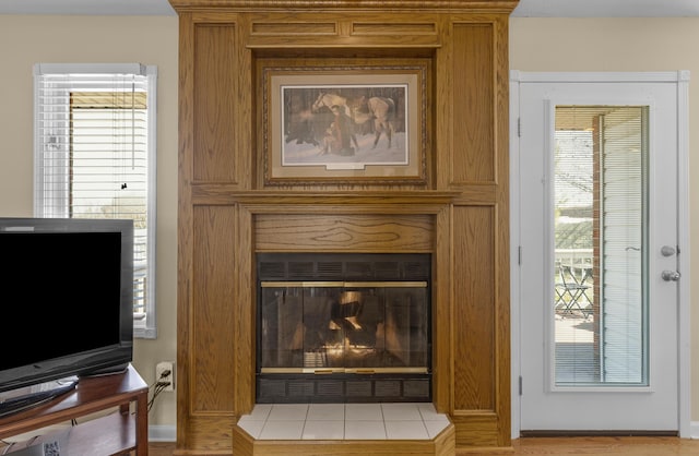 interior details with a glass covered fireplace