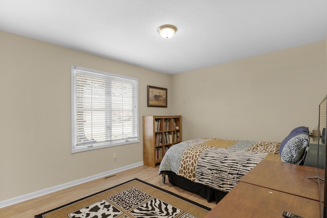 bedroom featuring visible vents, baseboards, and light wood-style flooring