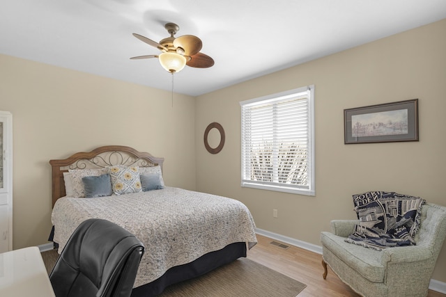 bedroom with visible vents, ceiling fan, baseboards, and light wood-style floors