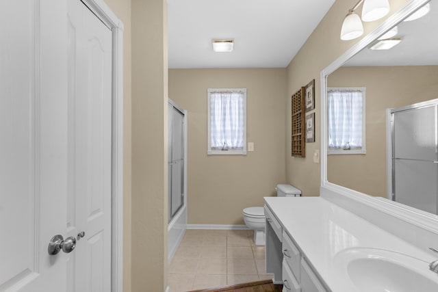 full bathroom with tile patterned flooring, toilet, vanity, and baseboards