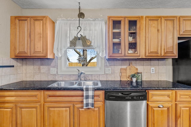 kitchen with tasteful backsplash, glass insert cabinets, dishwasher, dark stone countertops, and a sink