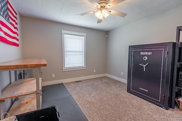 workout room featuring visible vents, baseboards, a textured ceiling, and ceiling fan