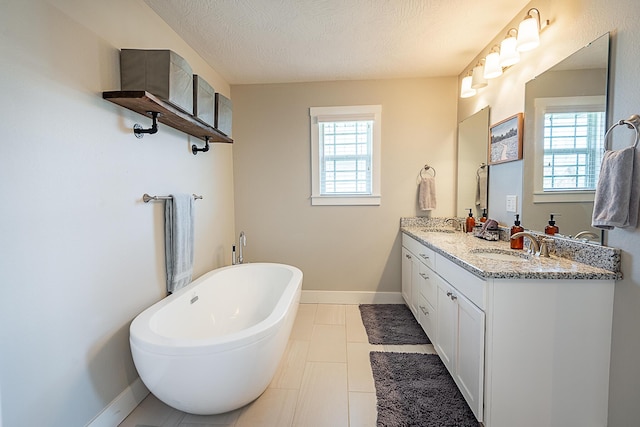 full bath with double vanity, a soaking tub, baseboards, and a sink