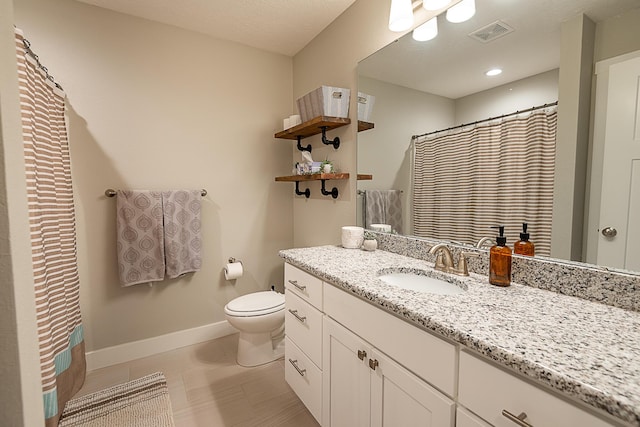 bathroom featuring tile patterned flooring, visible vents, baseboards, toilet, and vanity