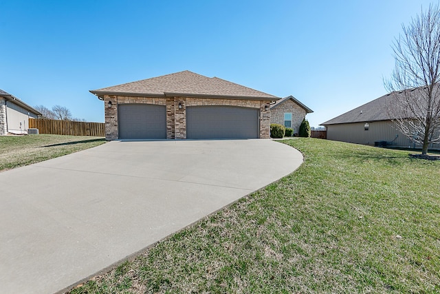 view of front facade featuring a front lawn, fence, concrete driveway, an attached garage, and brick siding