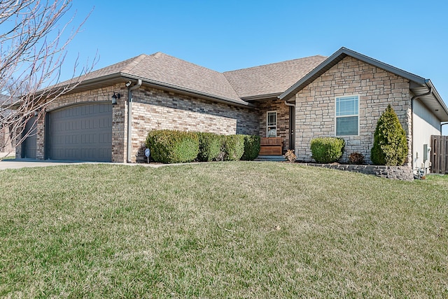 view of front of property featuring a front lawn, a garage, and roof with shingles