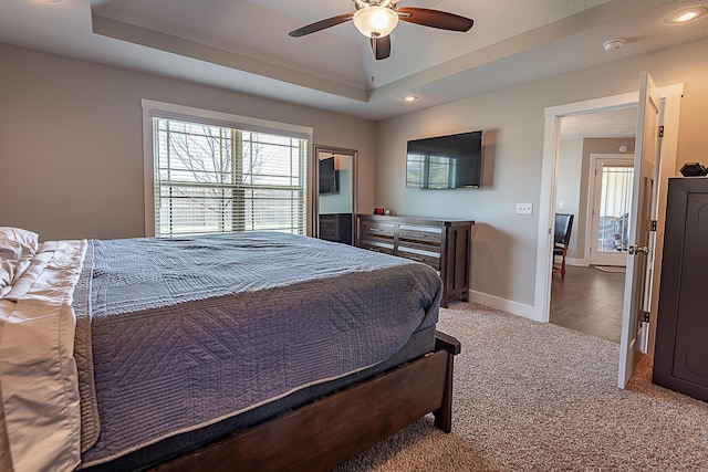 bedroom with recessed lighting, baseboards, a raised ceiling, and carpet