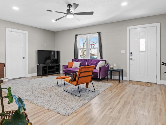 living room with a ceiling fan, recessed lighting, wood finished floors, and baseboards