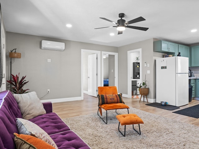 living area featuring a wall unit AC, recessed lighting, baseboards, and light wood finished floors