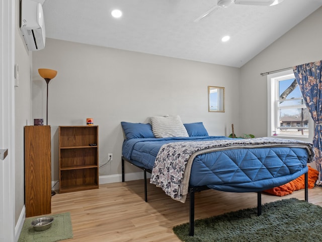 bedroom with light wood finished floors, baseboards, lofted ceiling, recessed lighting, and a wall mounted AC