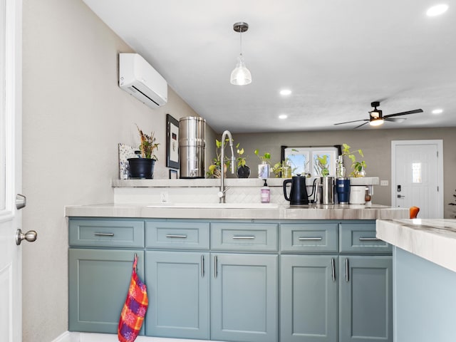 kitchen with pendant lighting, an AC wall unit, light countertops, recessed lighting, and a ceiling fan