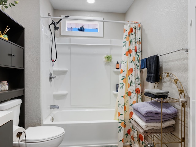 full bath featuring vanity, shower / tub combo, toilet, and a textured wall