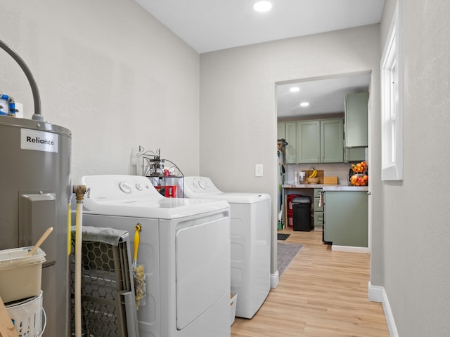 laundry area with washer and dryer, recessed lighting, light wood-style flooring, and water heater