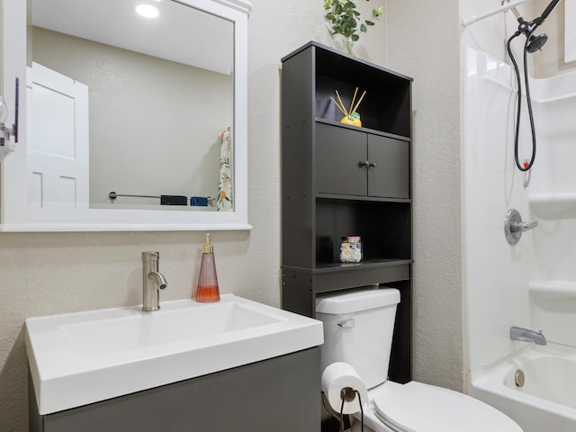 bathroom with vanity, toilet, a textured wall, and shower / bath combo with shower curtain