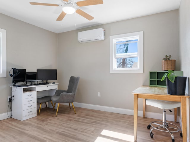 home office with an AC wall unit, light wood-type flooring, baseboards, and a ceiling fan