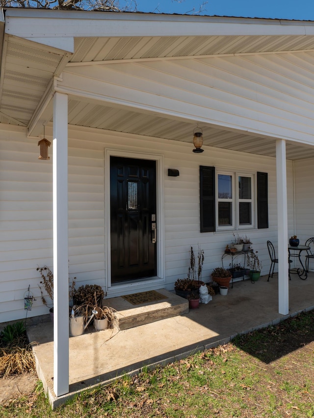 view of exterior entry with a porch