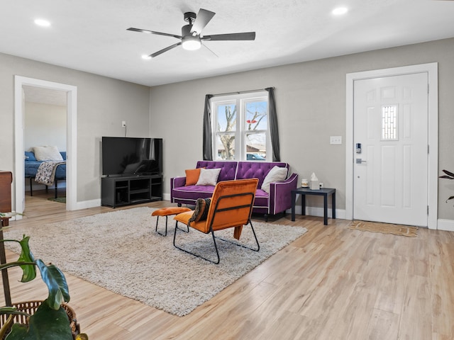 living room with recessed lighting, a ceiling fan, baseboards, and wood finished floors