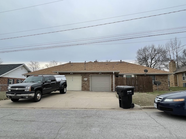 view of front of home with fence, brick siding, driveway, and a shingled roof