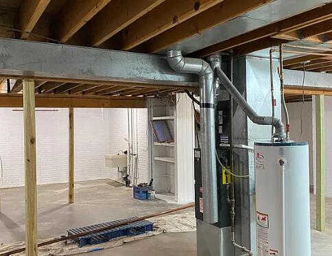 unfinished basement featuring gas water heater and a sink