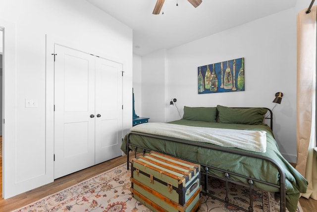 bedroom with ceiling fan, a closet, and wood finished floors