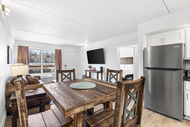 dining space featuring light wood-style floors